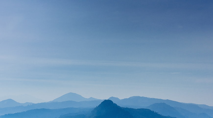 Serene Blue Mountain Landscape with Hazy Sky