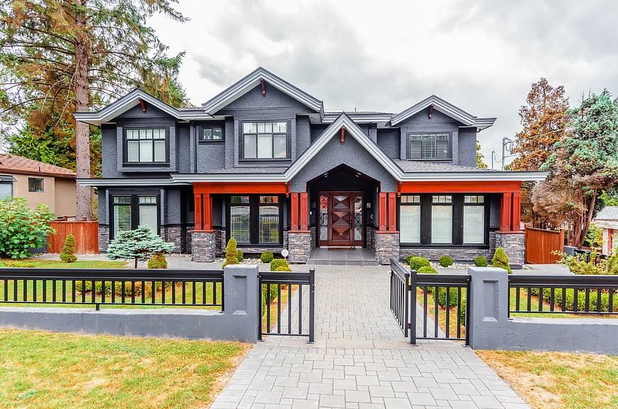 Modern Dark Gray House with Orange Accents and Stone Base