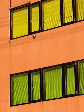 Colorful Orange Building Facade with Green Blinds