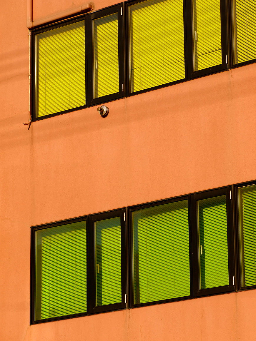 Colorful Orange Building Facade with Green Blinds
