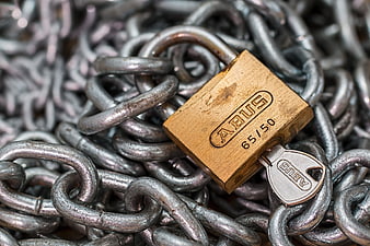 Gold Abus Padlock Securing Heavy Metal Chain Links