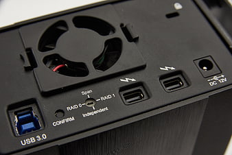 Close-up of black external hard drive enclosure with USB 3.0 and RAID settings