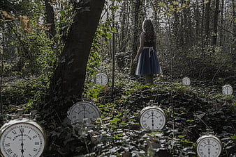 Woman in Blue Dress Walking Through Forest with Vintage Pocket Watches