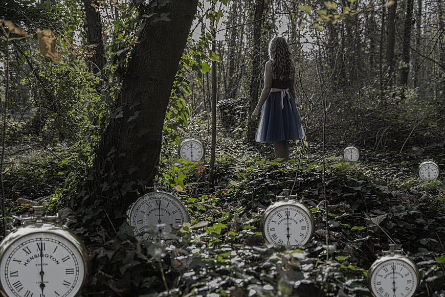 Woman in Blue Dress Walking Through Forest with Vintage Pocket Watches