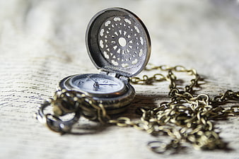 Vintage pocket watch on old handwritten letter