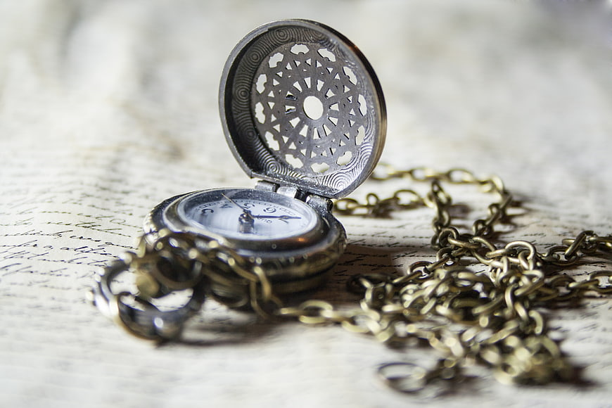 Vintage pocket watch on old handwritten letter