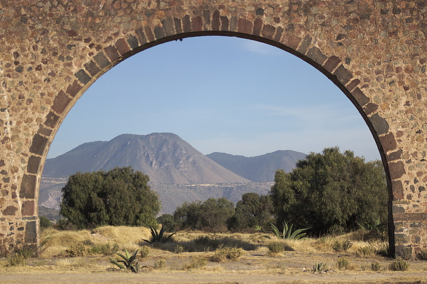 Stone arch framing distant mountain landscape