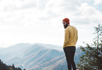Bearded Man in Orange Beanie Looking at Mountain View