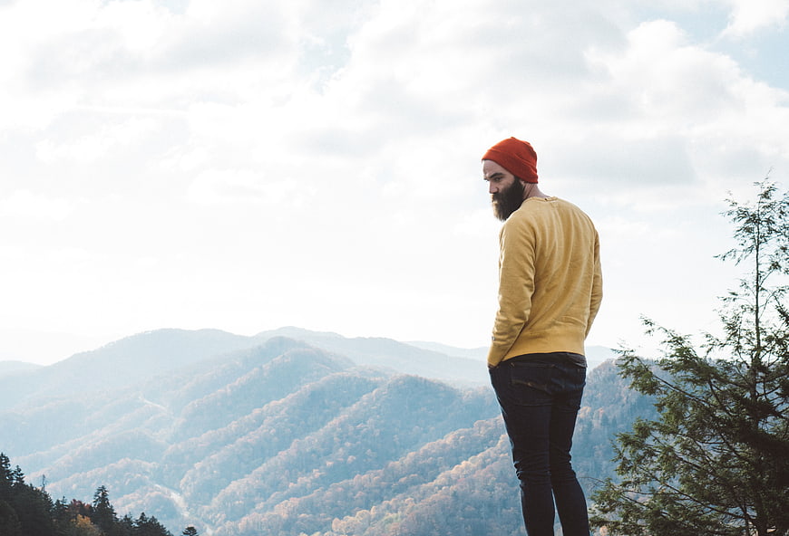 Bearded Man in Orange Beanie Looking at Mountain View