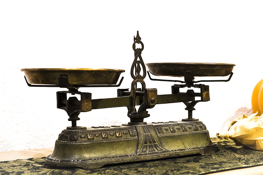 Antique Brass Balance Scale on Patterned Fabric
