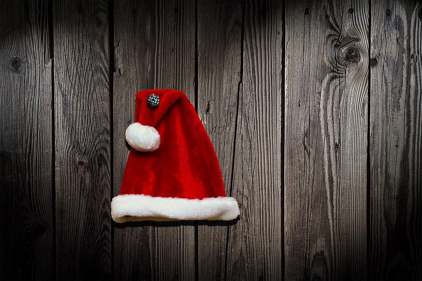 Red Santa Claus Hat on Dark Wooden Background
