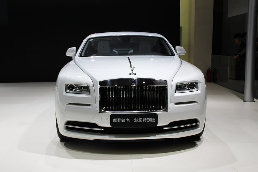Front view of white Rolls-Royce luxury car at auto show
