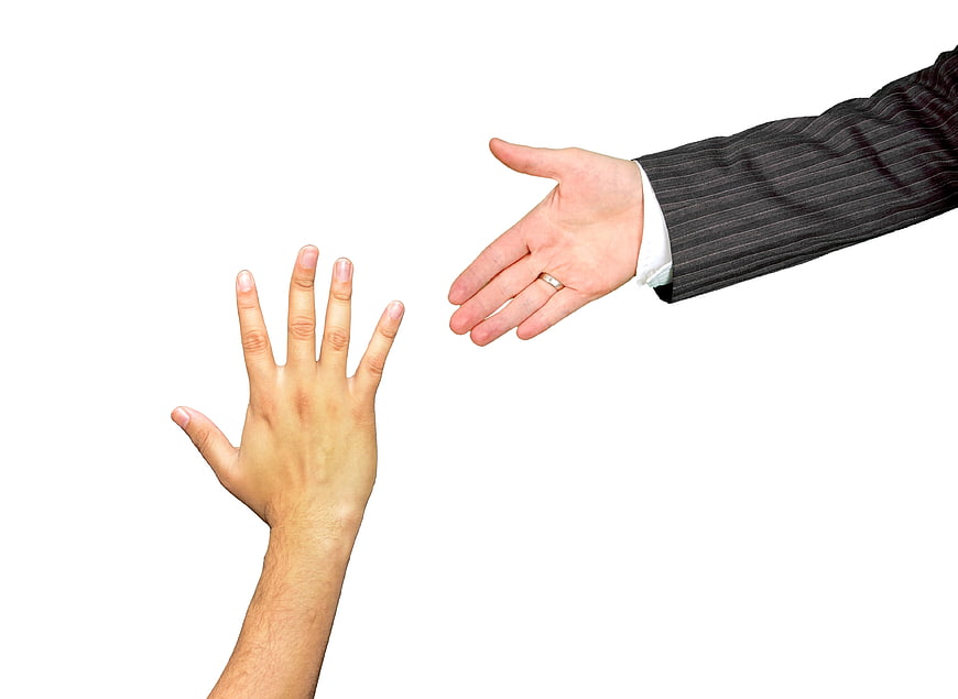 Businessman Hand Reaching Out to Help Another Person