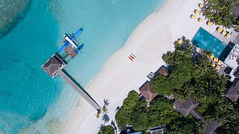 Aerial View of Tropical Beach Resort with Pier and Pool