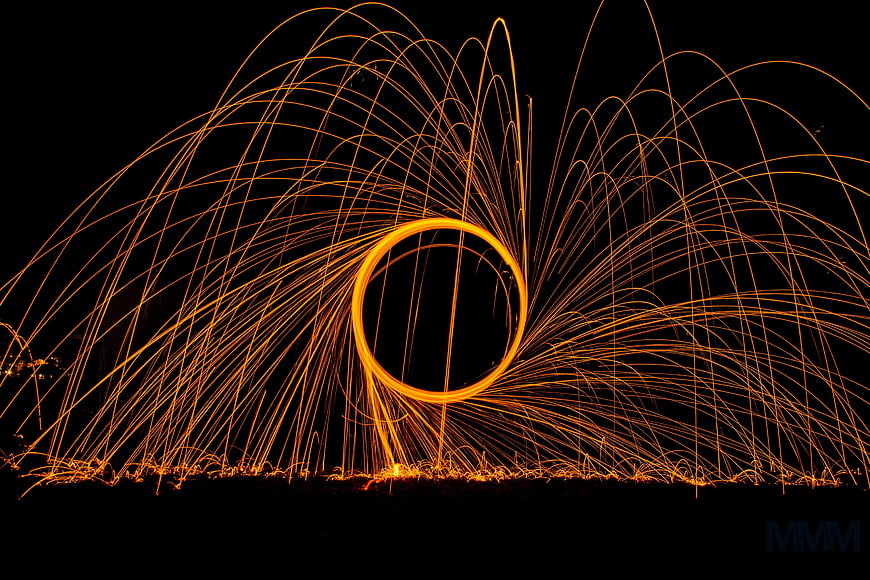 Abstract steel wool sparks forming a glowing circle at night