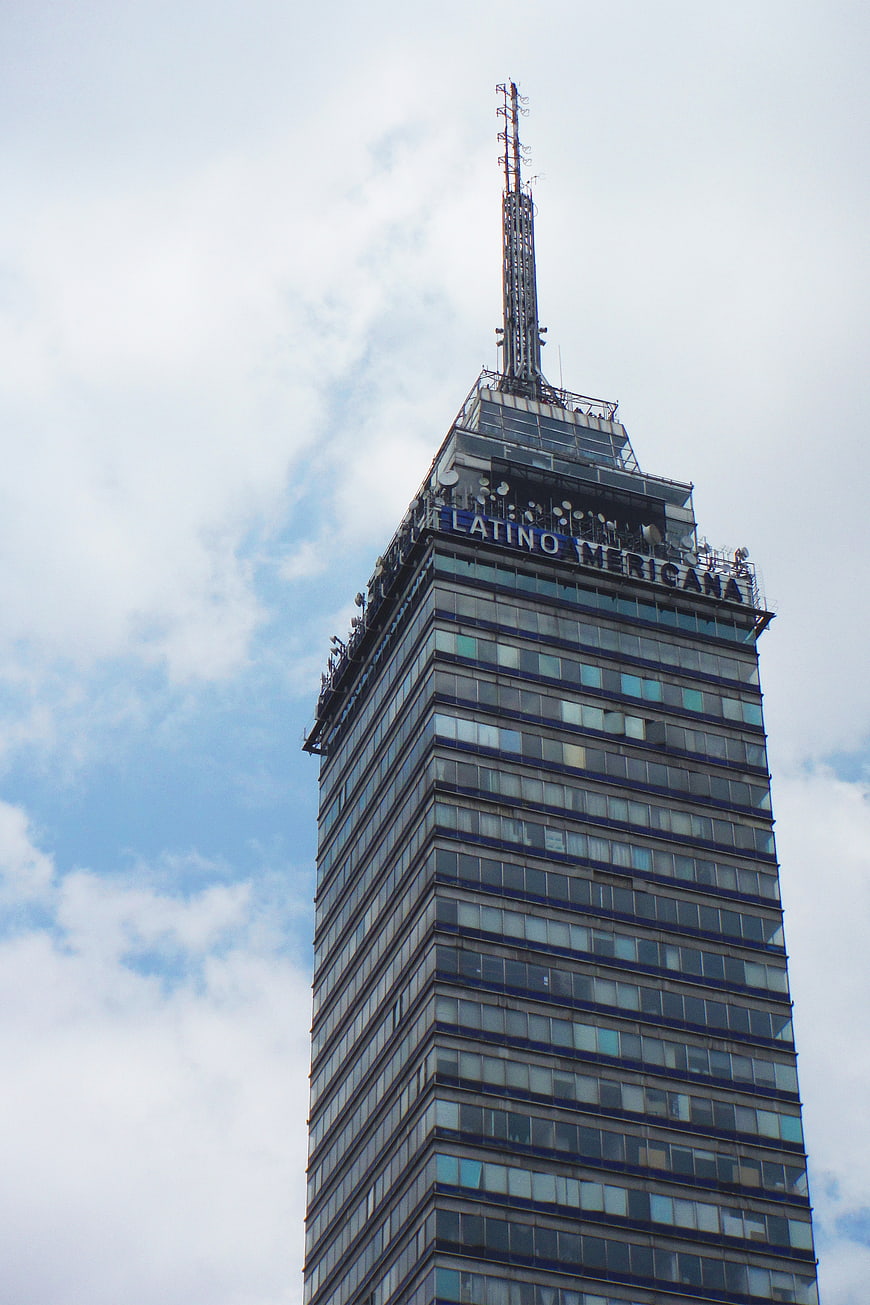 Low angle view of Torre Latinoamericana skyscraper against cloudy sky