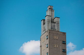 Modernist skyscraper tower against blue sky