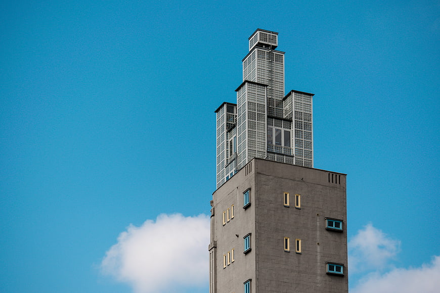 Modernist skyscraper tower against blue sky
