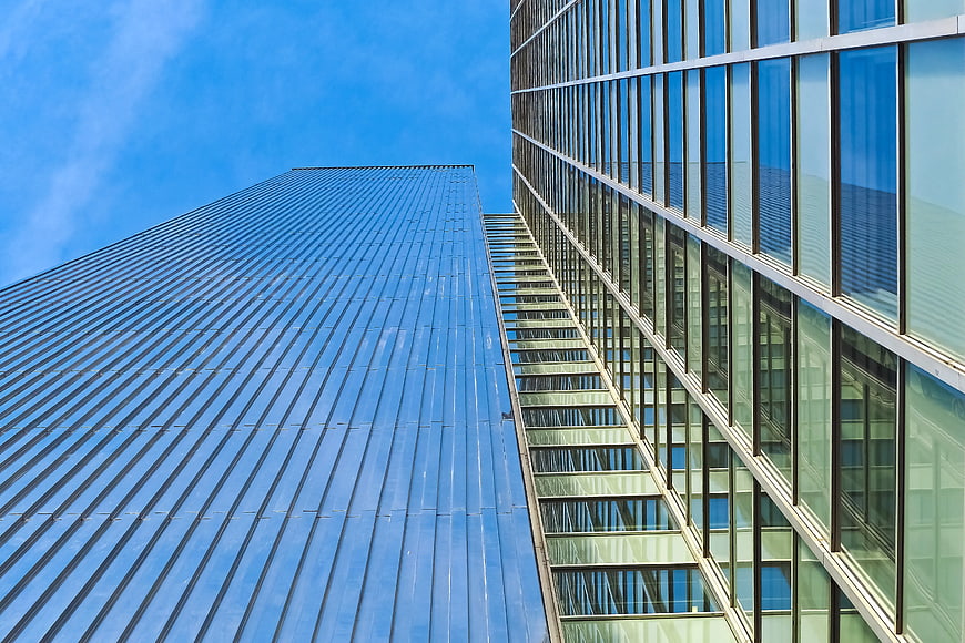 Low Angle View of Modern Glass Skyscrapers Against Blue Sky
