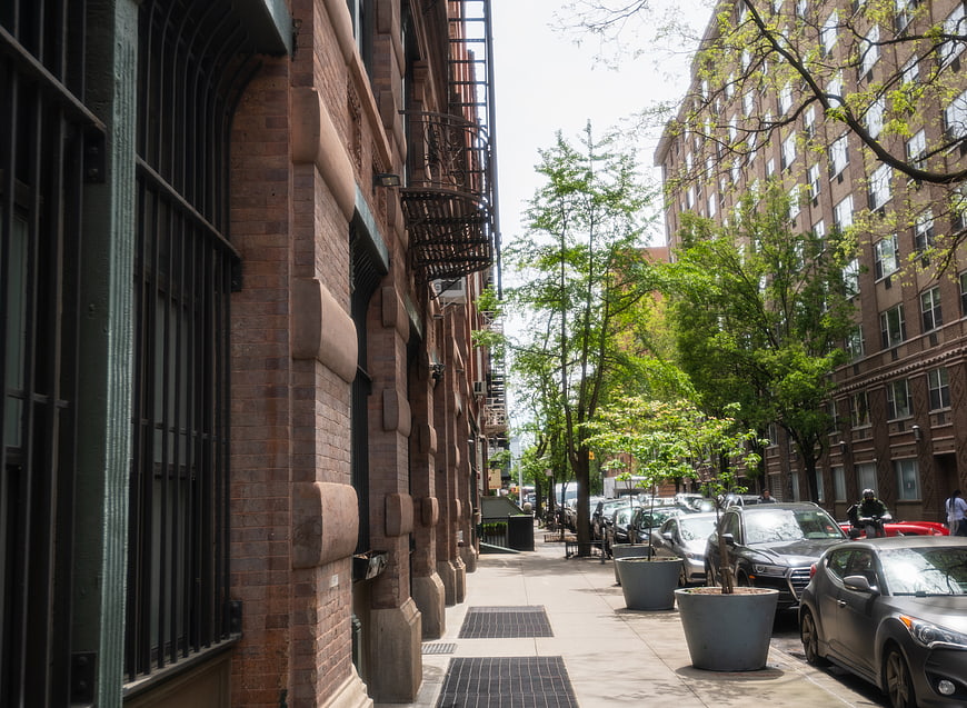 Urban Street Scene with Brick Buildings and Parked Cars