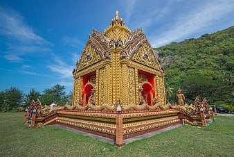 Golden Thai Temple with Naga Stairs and Blue Sky