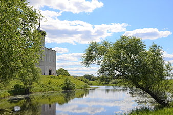 White Orthodox Church by River with Reflection