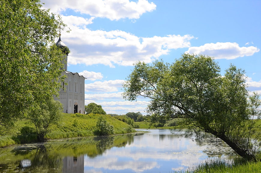 White Orthodox Church by River with Reflection