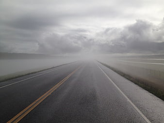 Foggy Highway Road Vanishing Into Gray Stormy Sky