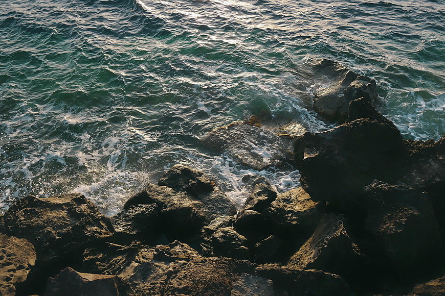 High Angle View of Ocean Waves Crashing on Rocky Shore