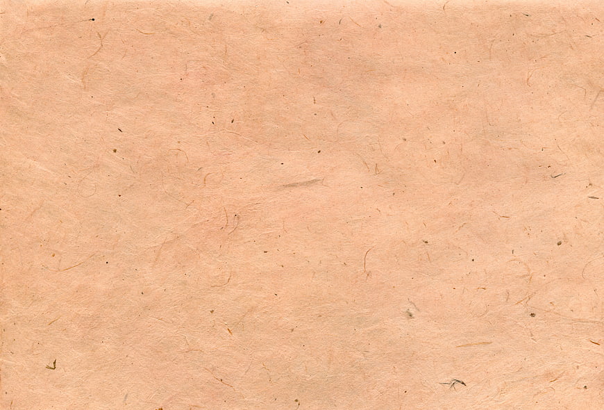 Textured beige handmade paper background with natural fibers