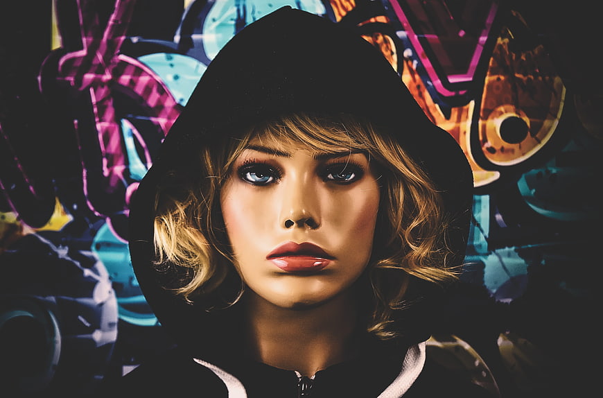 Mannequin Head In Black Hoodie Against Colorful Abstract Background