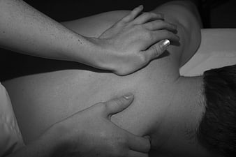 Close-up of hands performing therapeutic back massage