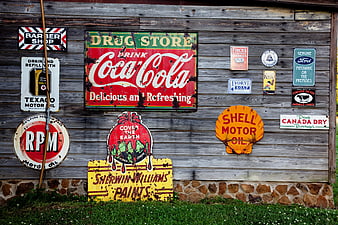 Vintage Tin Signs on Weathered Wooden Barn Wall
