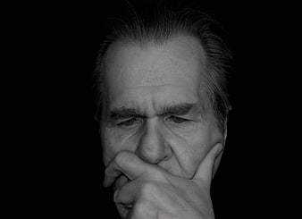 Black and white portrait of a man thinking with hand on chin