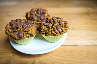 Homemade chocolate chip muffins on a wooden table