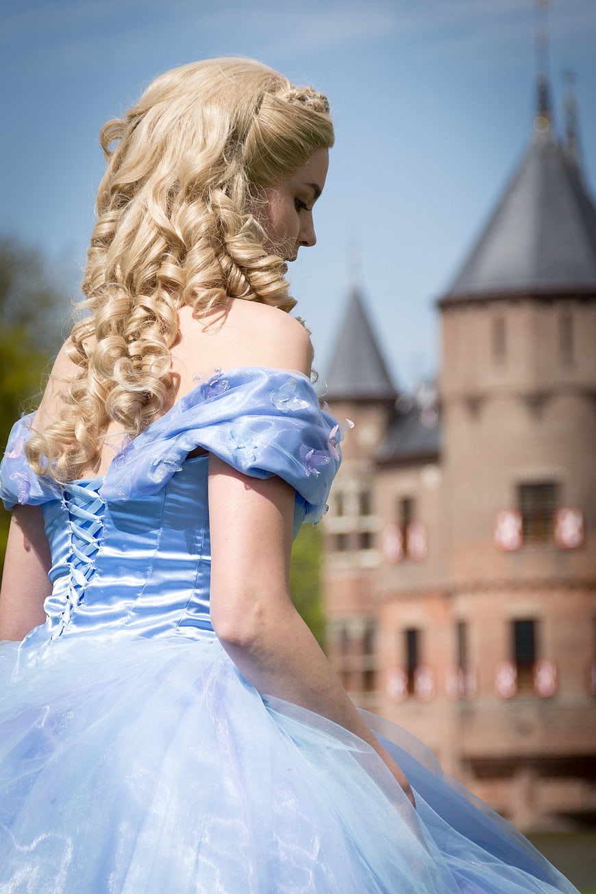 Blonde Woman in Blue Cinderella Dress at Castle