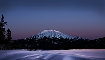 Snowy Mountain Peak at Dusk with Foreground Snow Drifts