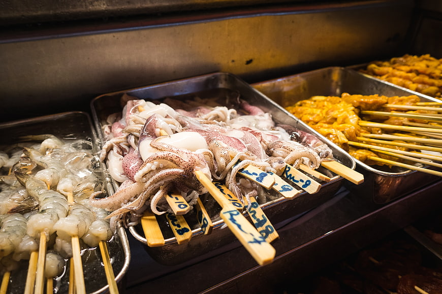 Raw seafood skewers and octopus for hot pot street food