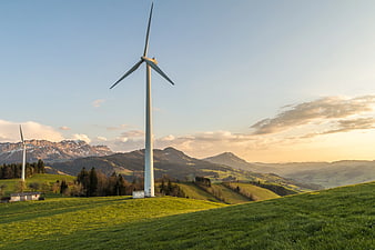 Wind Turbines on Green Hillside at Sunset