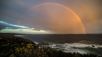 Dramatic Rainbow Over Coastal Ocean Landscape