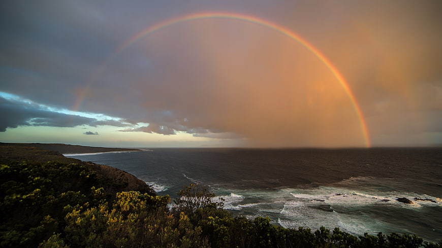 Dramatic Rainbow Over Coastal Ocean Landscape