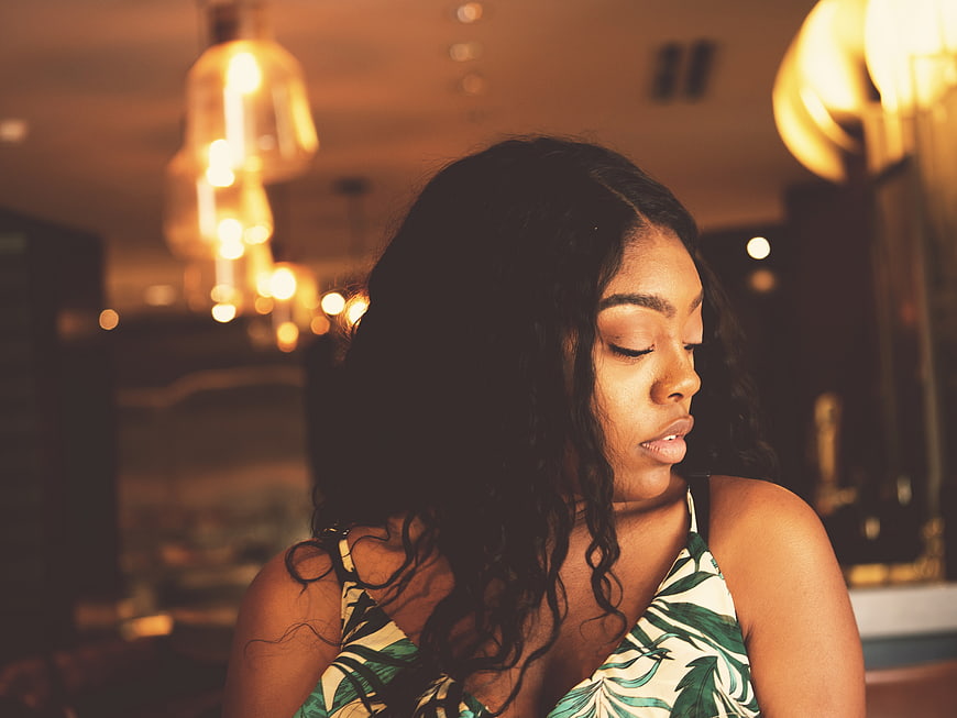 Contemplative African American Woman in Warm Indoor Lighting
