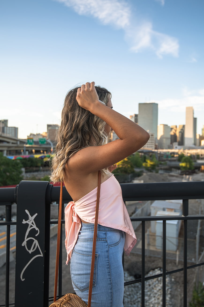 Woman in Pink Top Looking at City Skyline