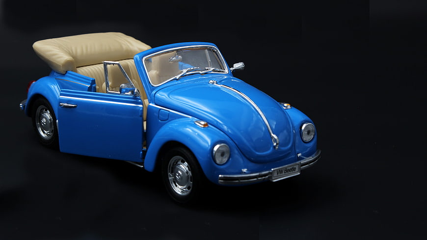 Blue VW Beetle Convertible Model Car on Black Background