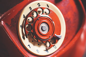 Close-up of vintage red rotary telephone dial