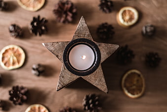 Top view of star-shaped wooden candle holder with tea light