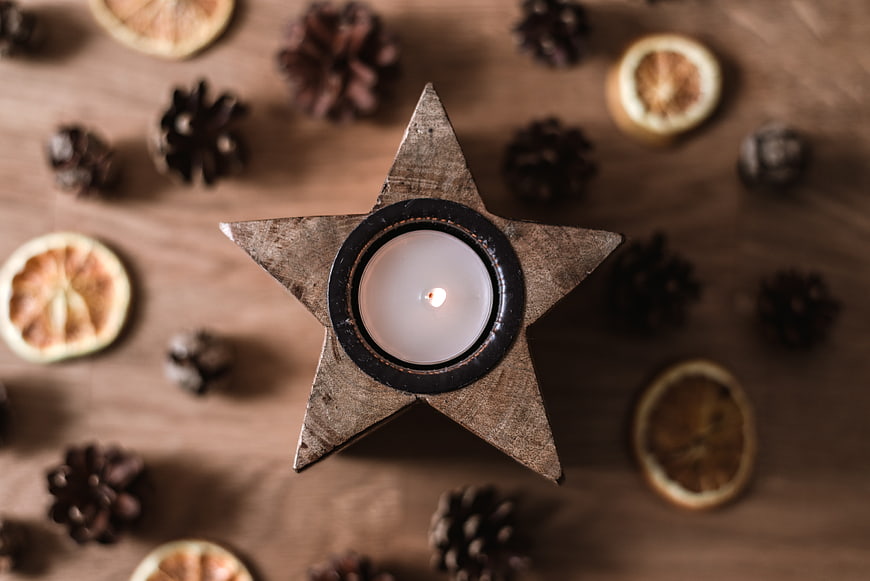 Top view of star-shaped wooden candle holder with tea light