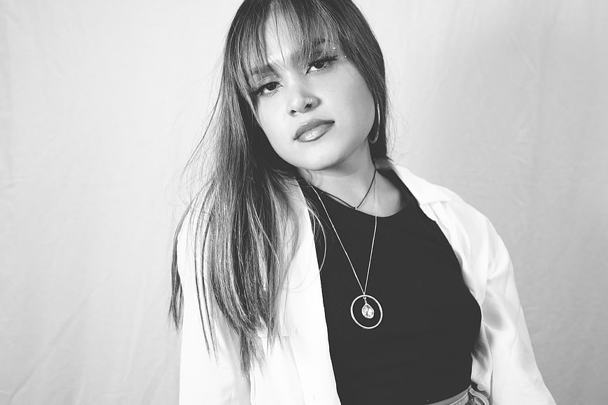 Black and white portrait of stylish young woman with bangs