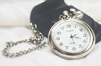 Vintage Silver Pocket Watch on White Fabric Background
