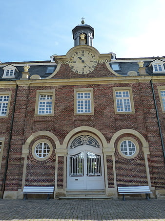 Historic Red Brick Building with Clock Tower and Arched Entrance